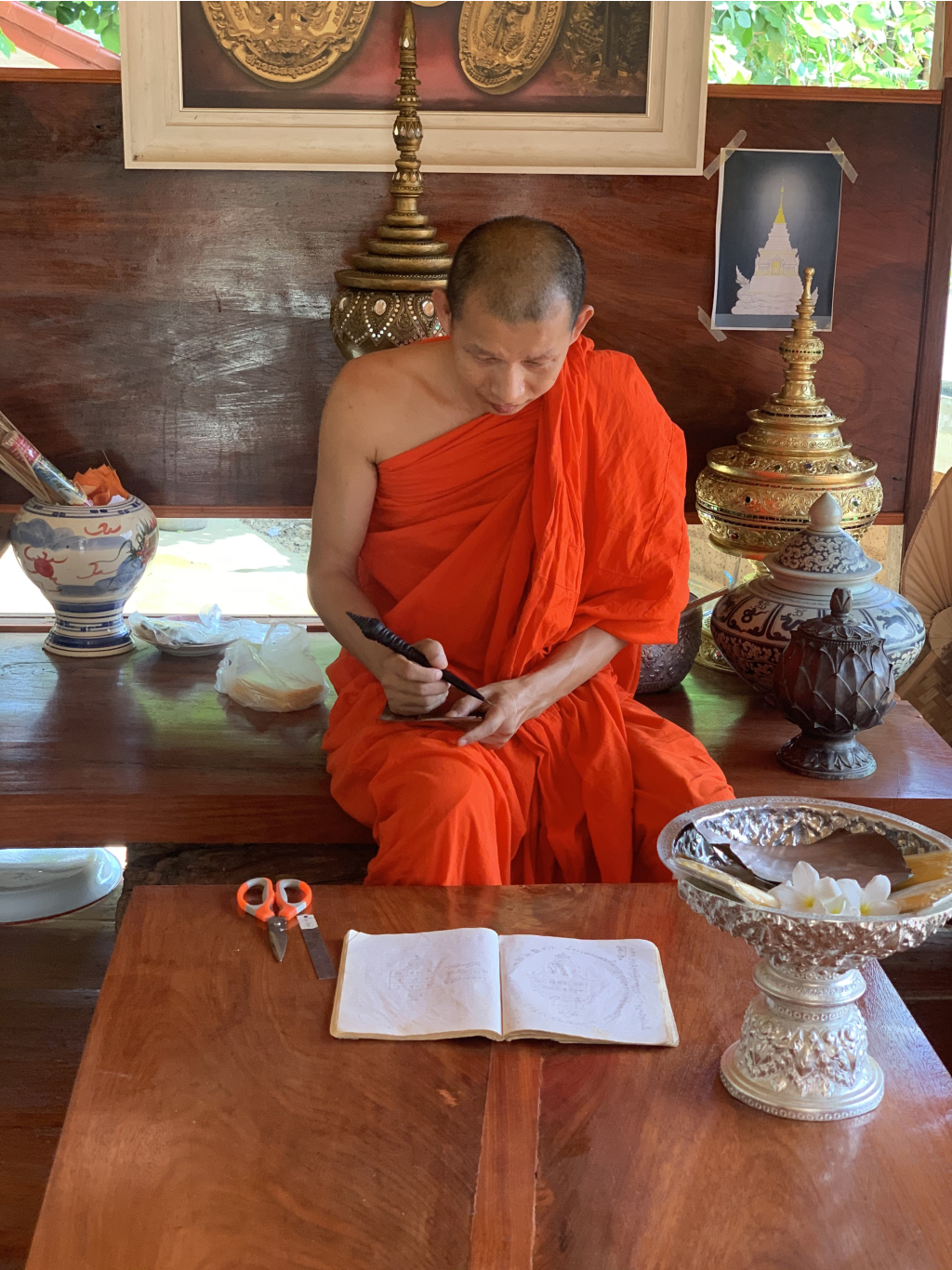 คำอธิบาย: ภาพ การสาธิตการลงยันต์ (ที่มา : คลังข้อมูลชุมชน) 